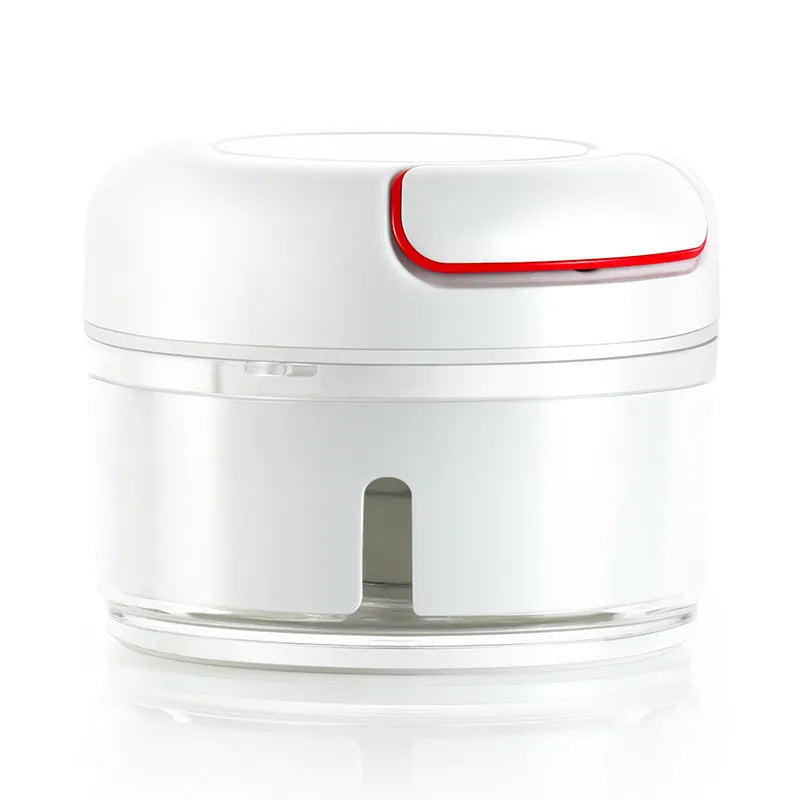 White and silver manual food chopper with stainless steel blades on a kitchen countertop.
