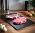 Black aluminium quick defrosting tray for thawing meat and frozen food without electricity.
