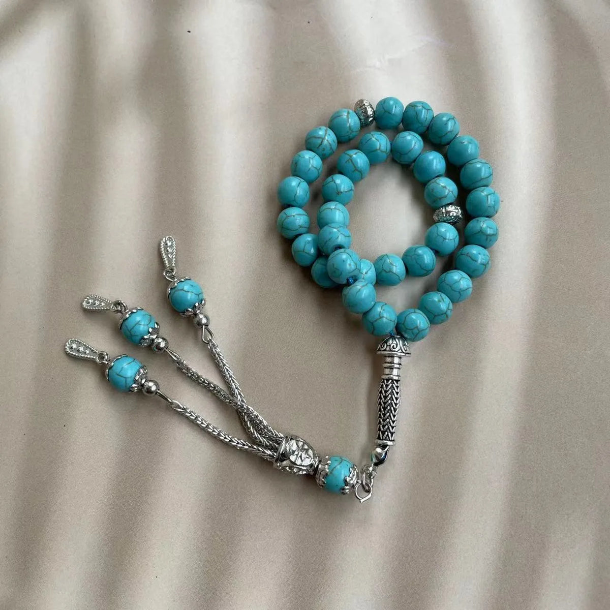 Handmade sky blue stone bead Muslim worship bracelet with 8mm beads on a white background