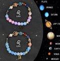 Complete set of twelve natural stone beaded bracelets laid out, each with a different zodiac sign charm.