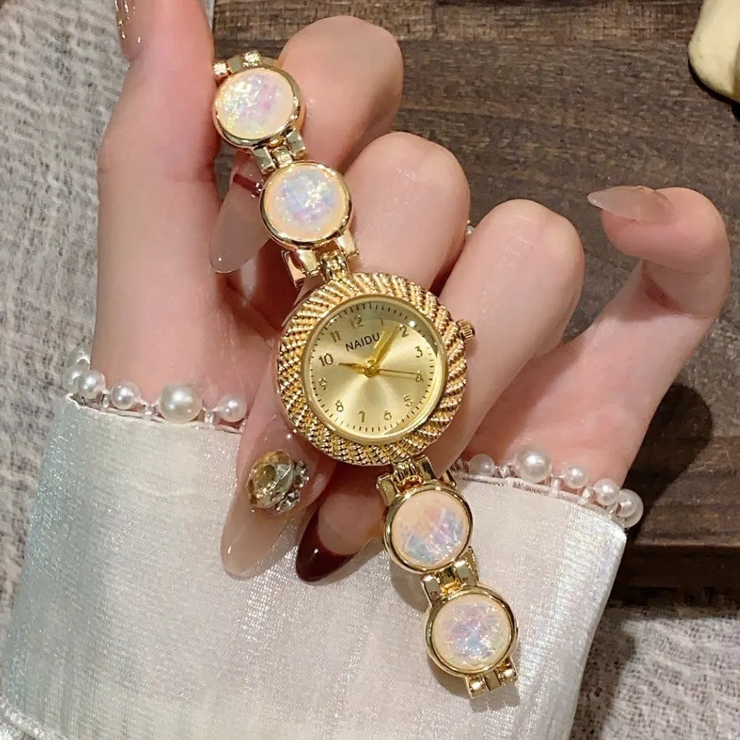 Women's quartz watch with round 25mm dial in milky white colour, zinc alloy case, and spiral crown.