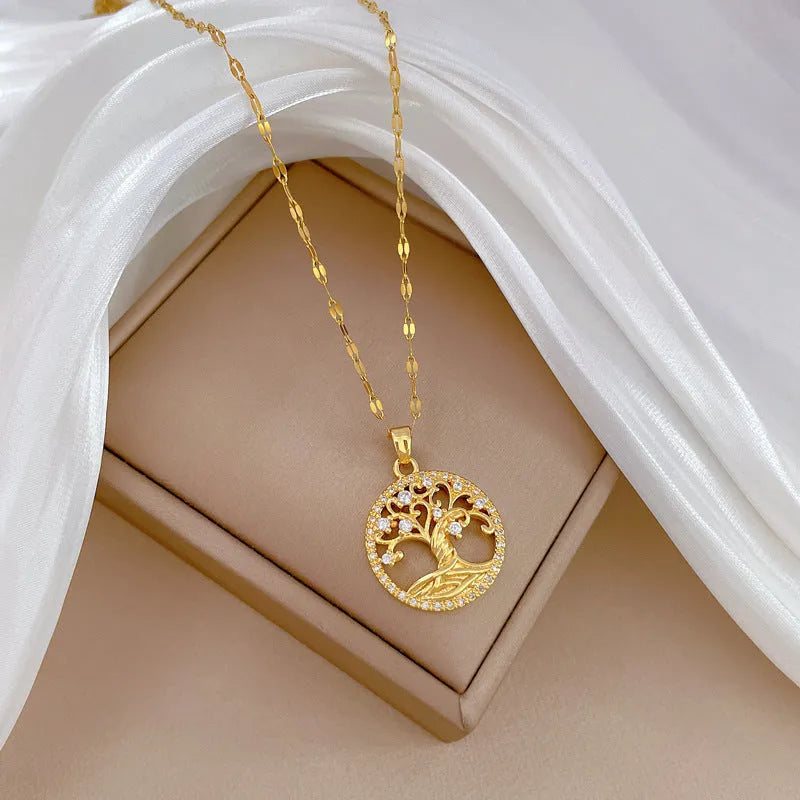Gold-plated cross pendant necklace with micro-inlaid mother of pearl and rhinestone design on an adjustable chain.