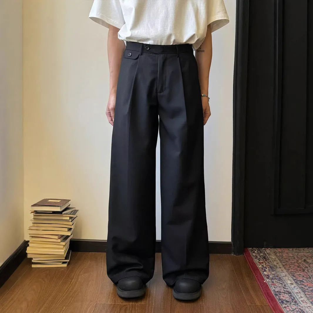 Men's straight-leg wide trousers in brown and black, showing loose fit and casual style.