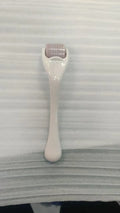 540 micro needle derma roller with black handle and purple wheel, showing adjustable needle sizes.