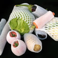 White foam protective net cover for apples, pears, peaches and oranges.