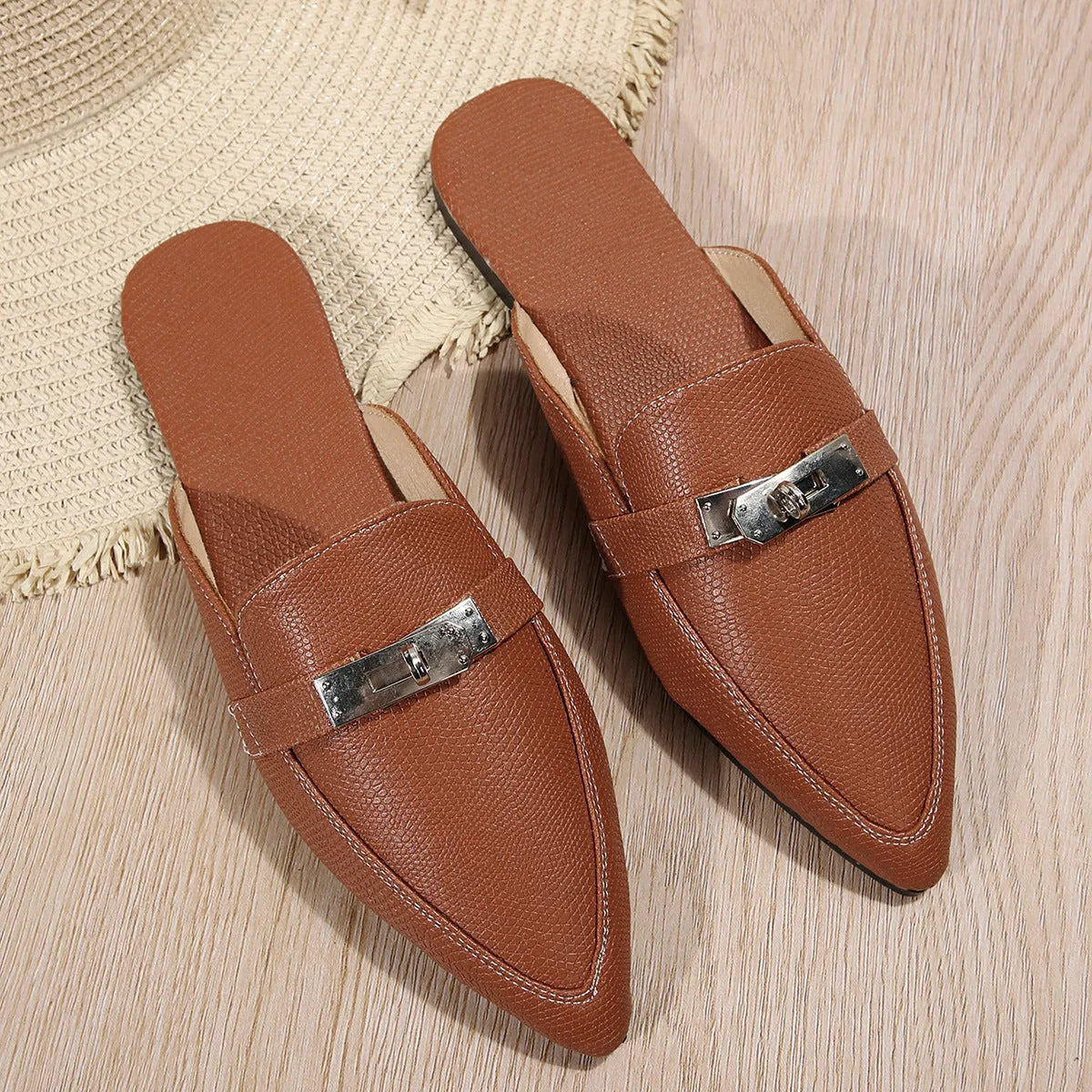 Light brown women's pointed toe slippers with a low heel, showing PU upper and rubber sole.