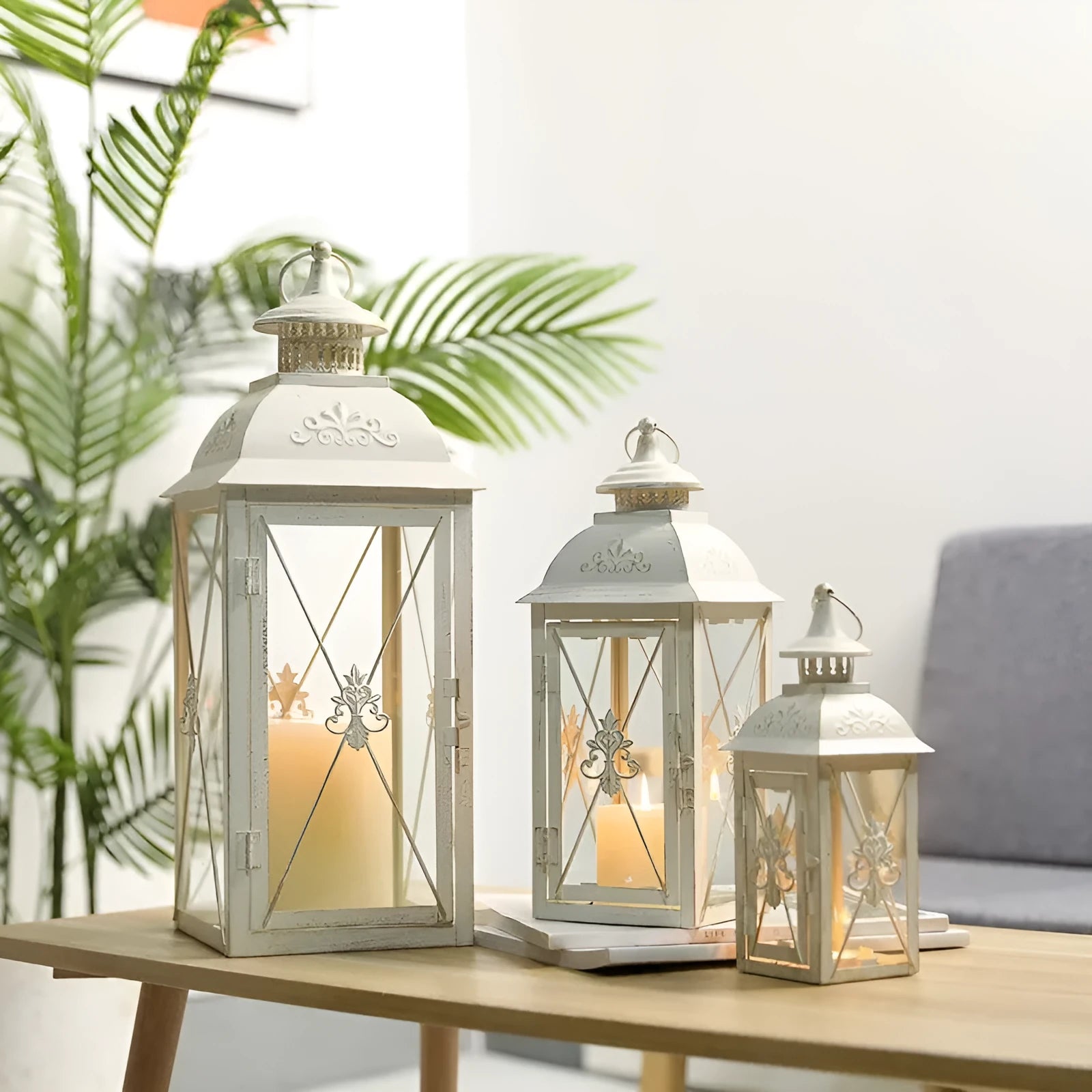 European wrought iron storm lantern with tempered glass in black or white gold finish, shown in small, medium, and large sizes.