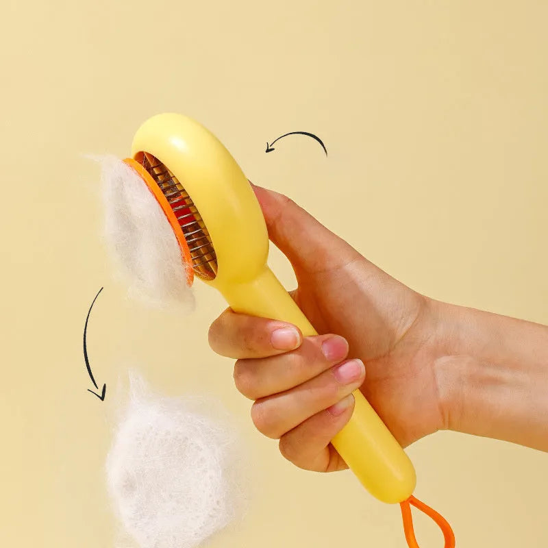 Small yellow duck-shaped pet grooming comb with open-section needle brush design for cat and dog hair removal