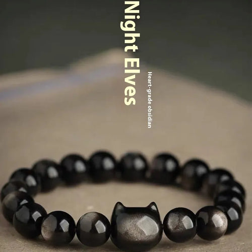Obsidian cat head bracelet with round beads in gold or silver style, showing cat charm detail.