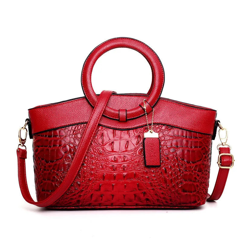 Ladies fashion handbag in multiple colours showing zipper compartments and shoulder strap