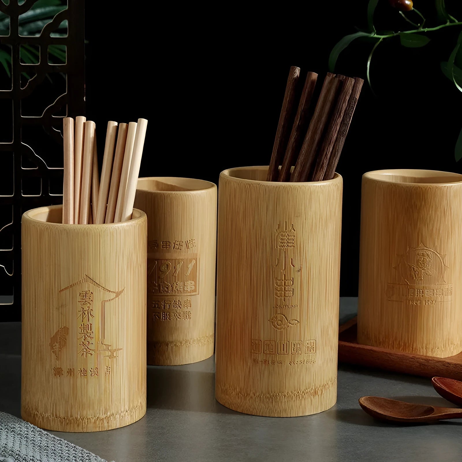 Wild bamboo chopsticks holder tube in various sizes on a wooden table.