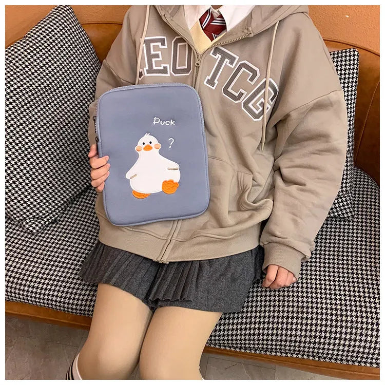 Blue cotton tablet case with cartoon duck embroidery and a zipper closure.