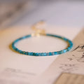 Women's natural blue apatite crystal bracelet with diamond-cut facets on adjustable band
