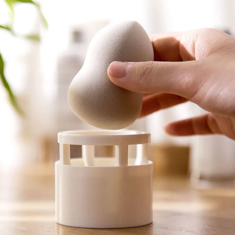 Pink plastic beauty egg stand in girly heart style for dustproof cosmetics storage on a bedroom surface
