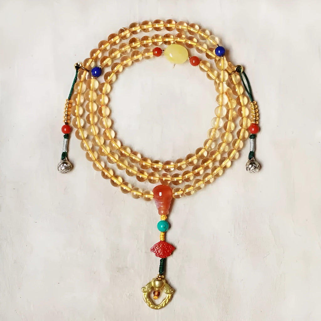 Yellow natural citrine bracelet with 1mm beads and filament accessory details on a wrist.