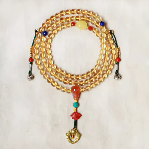 Yellow natural citrine bracelet with 1mm beads and filament accessory details on a wrist.