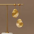 Chinese style asymmetrical floral earrings with zircon detailing in gold or silver finish