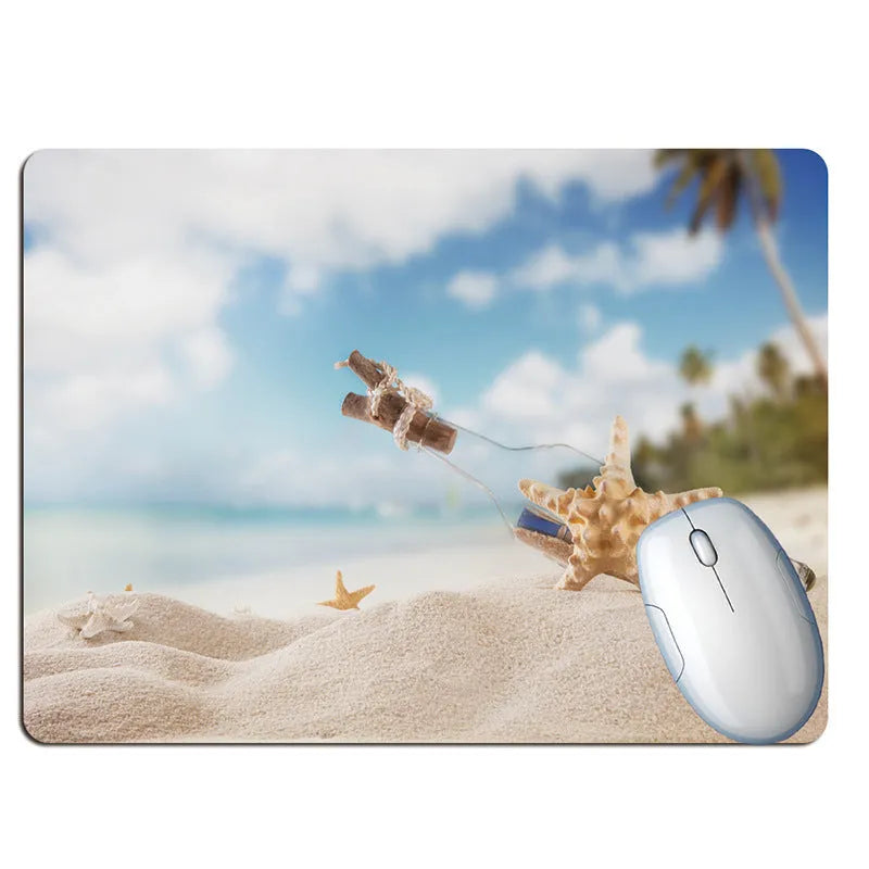 Wishing bottle summer beach holiday themed mouse pad on a desk, showing non-slip rubber base.