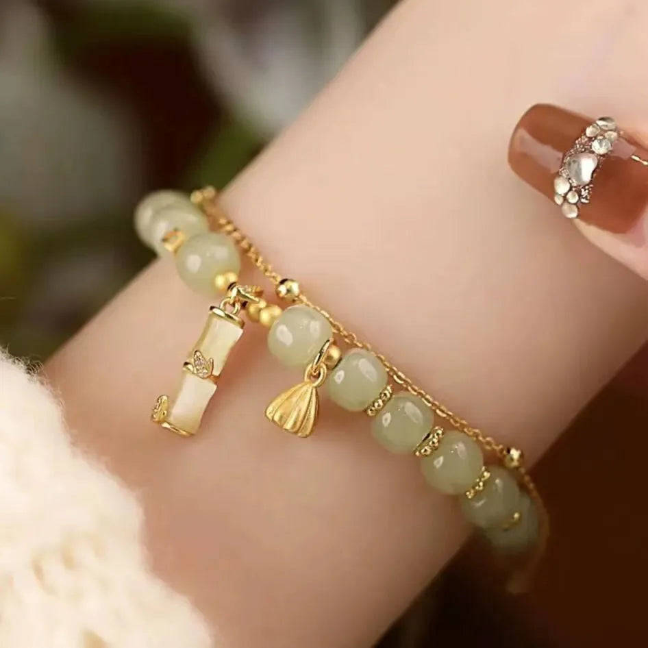 Retro style bamboo bracelet with coloured glass floral beads and ruyi design