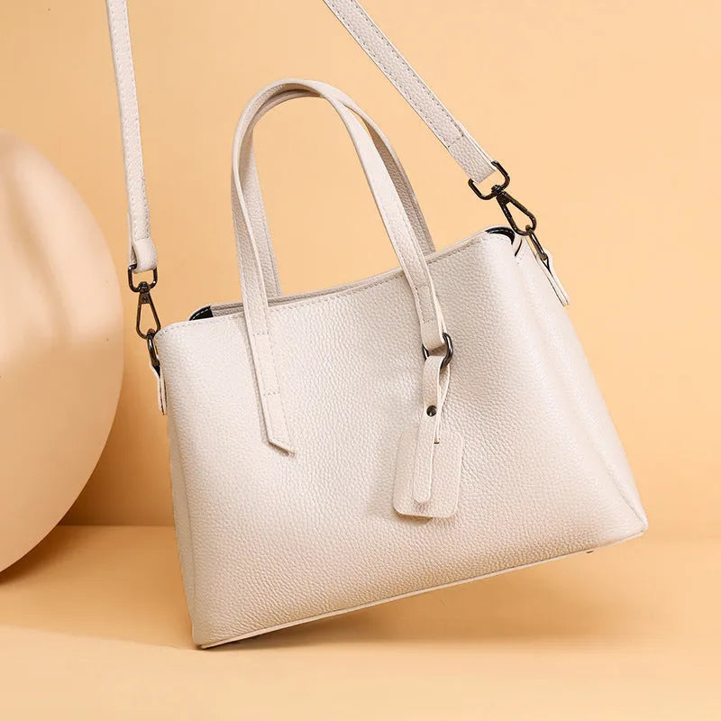 Genuine cowhide leather women's handbag in horizontal square shape with shoulder strap and organisational compartments