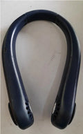 A white rechargeable bladeless neck fan hanging around a person's neck, showing its compact, hands-free design.