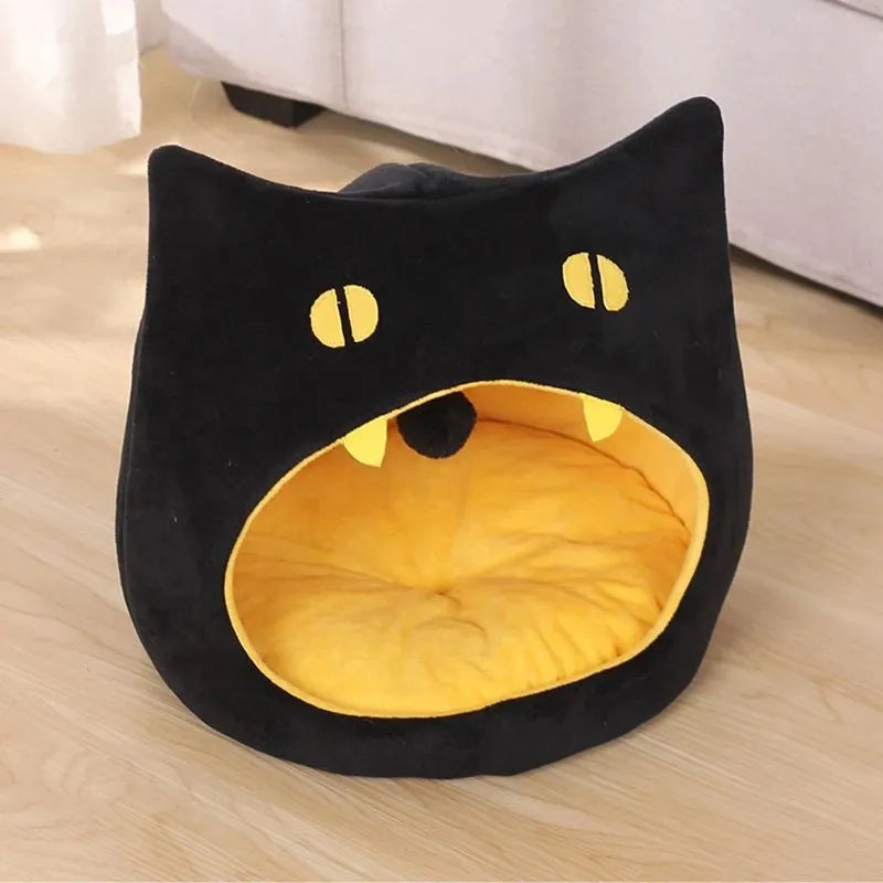 Grey cat-shaped covered pet bed with a removable cushion, shown on a wooden floor.