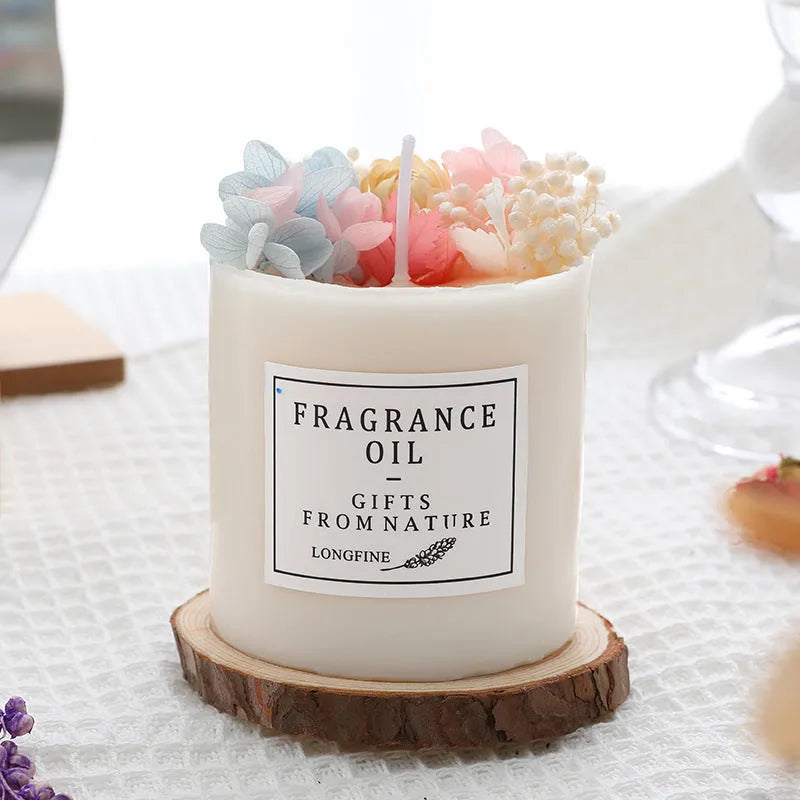 Aromatherapy candle with dried flowers on surface, shown in gift box with chip base.