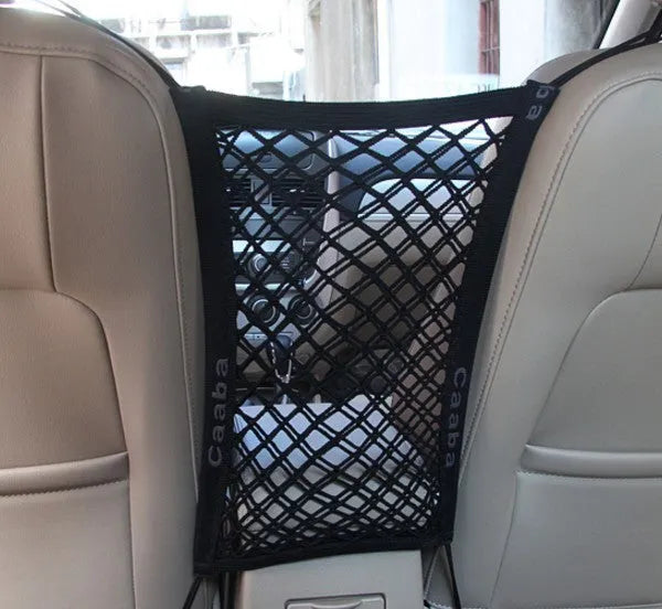 Black elastic nylon car pet fence isolation net installed on middle seat with hooks.