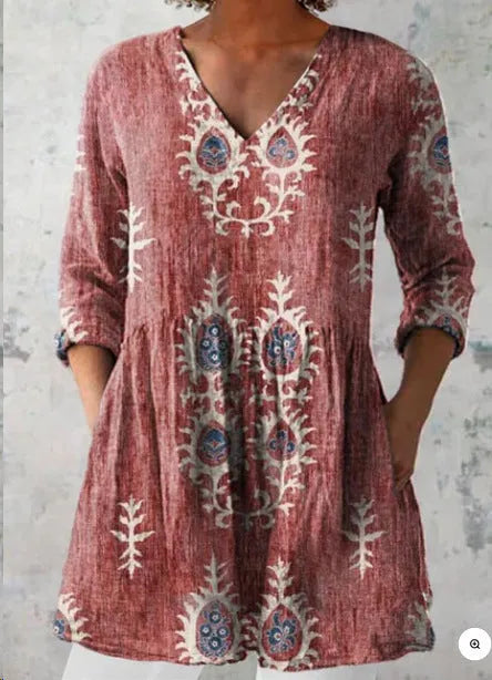Women's floral wave print dress with wide waist and three-quarter length sleeves on a hanger.
