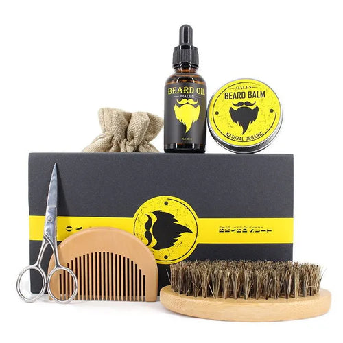 six-piece beard care kit with beard cream, beard oil, peach wood comb, bristle brush, stainless steel scissors, and linen bag on a wooden surface