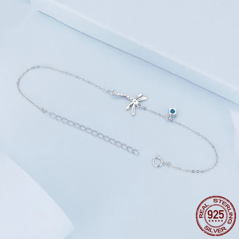Sterling silver white gold plated dragonfly bracelet with dripping zircon stones on white background