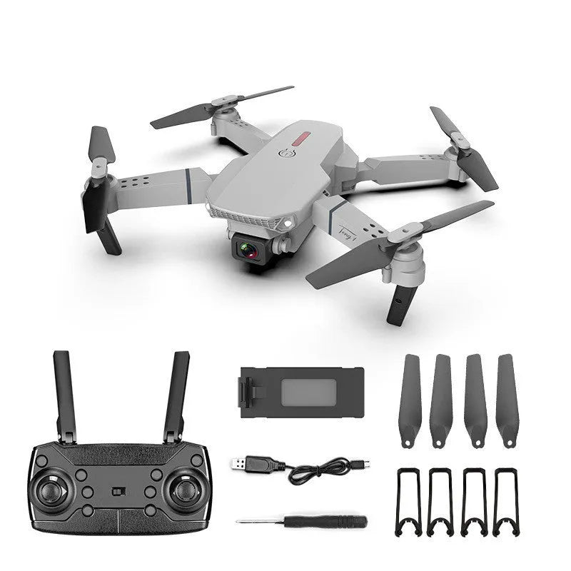 Grey foldable 4K dual camera aerial drone with remote control and spare blades