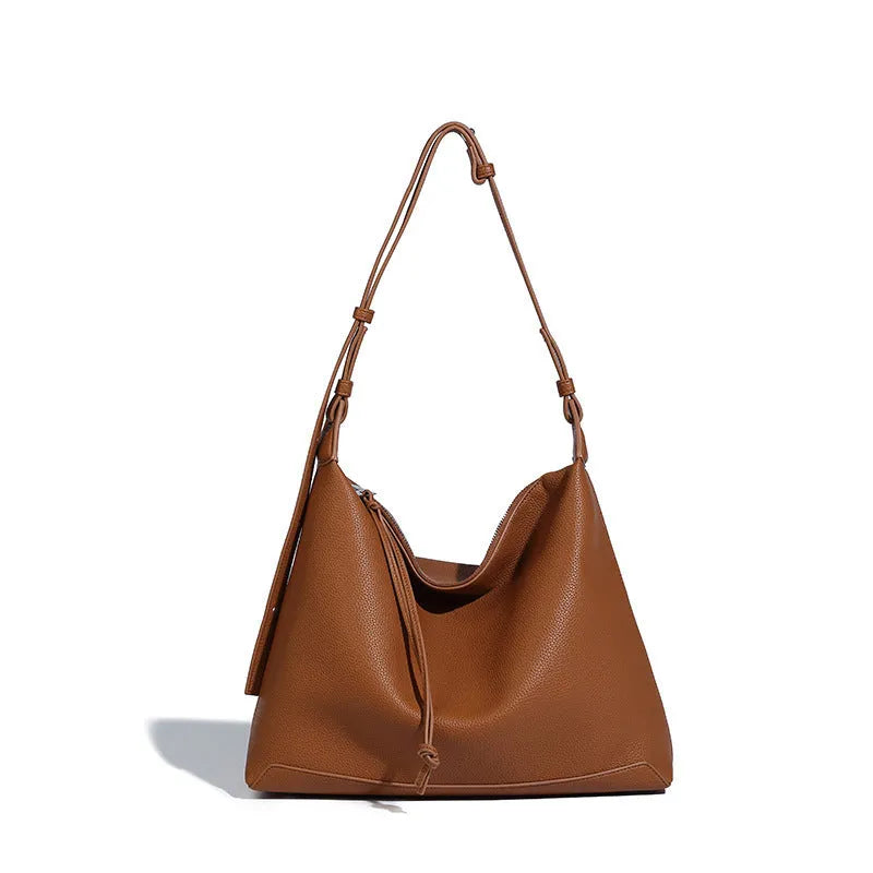 Soft PU leather messenger bag in caramel colour showing large capacity and shoulder strap.