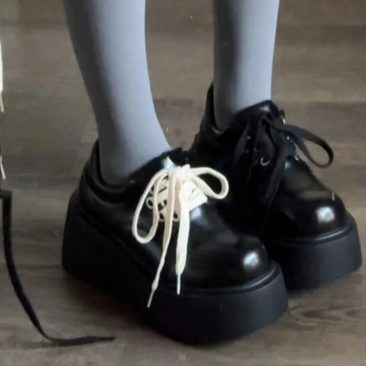 Matte black women's lace-up shoes with a chunky English muffin heel and thick rubber sole.