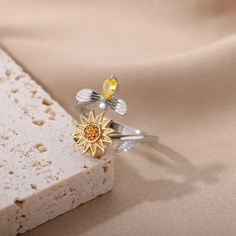 Adjustable copper decompression ring with rotatable element in gold or platinum finish