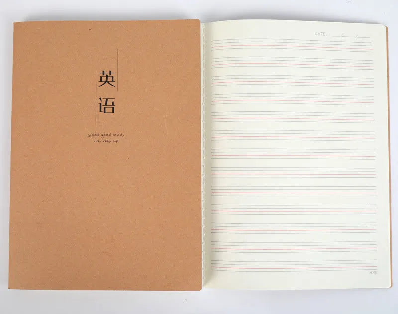 Softcover thread-bound notebook open on a table, showing flat-lay binding and lined paper.