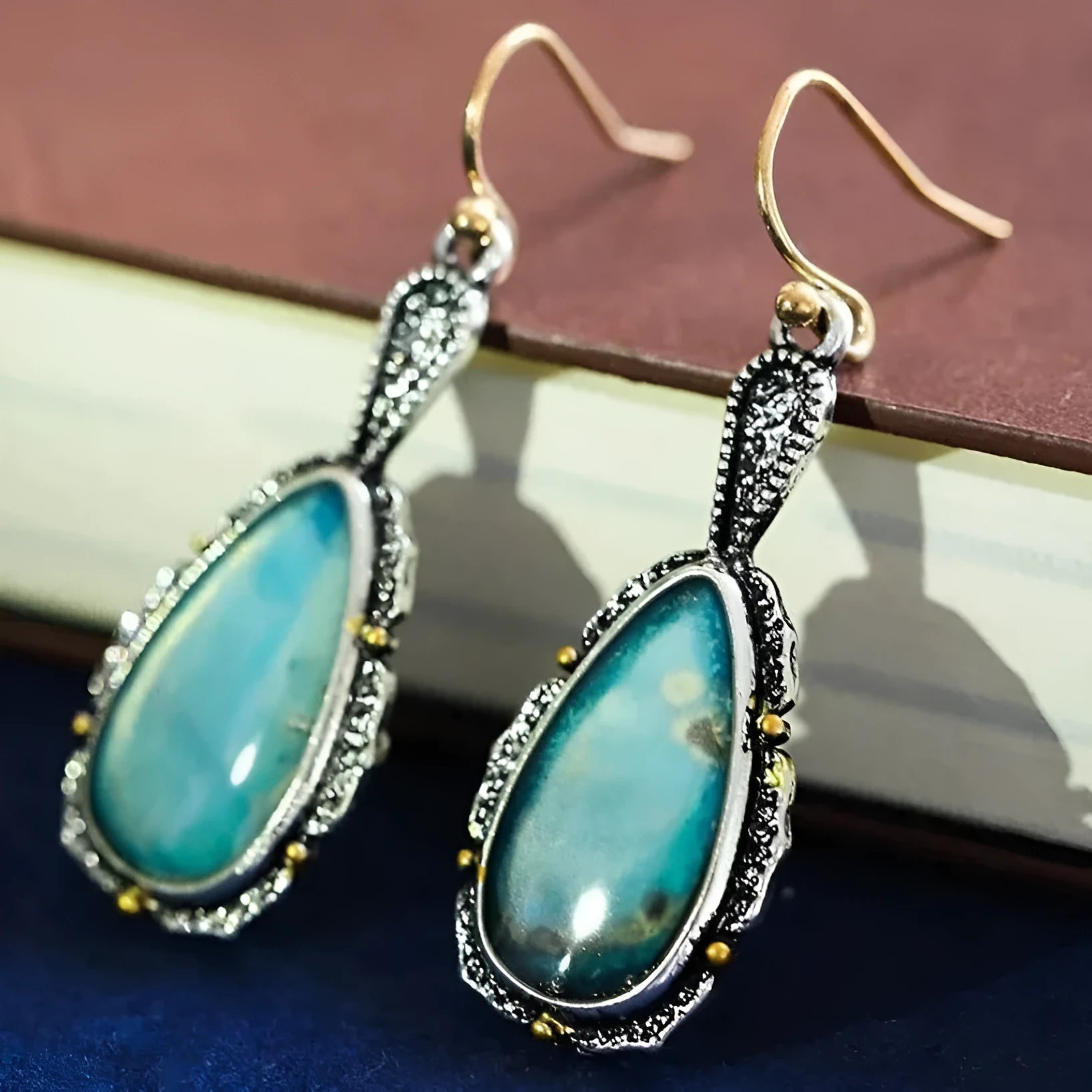 Antique silver turquoise teardrop petal drop earrings on a woman, alloy construction, vintage style