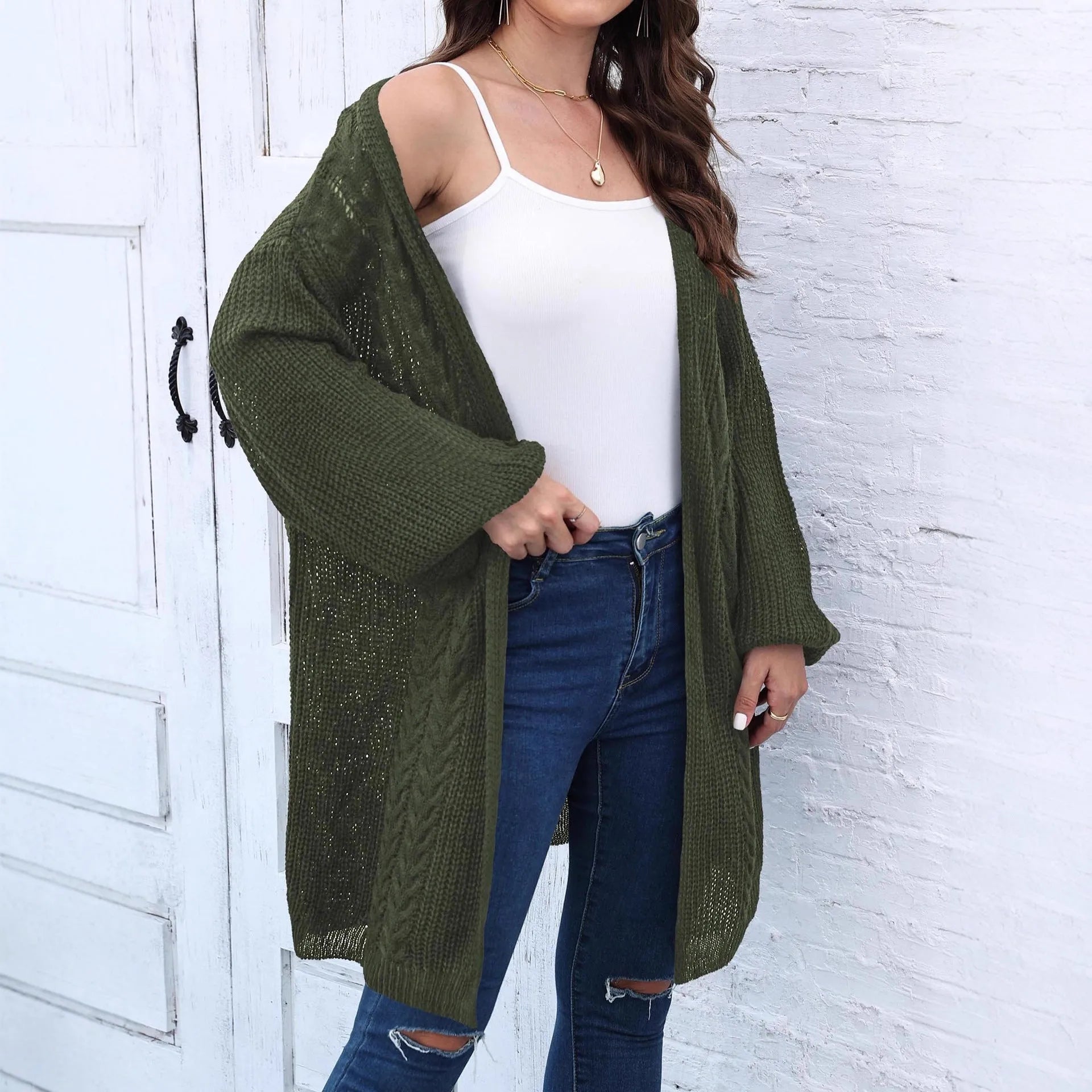 Women's loose fit acrylic sweater coat in a solid colour, shown on a hanger.
