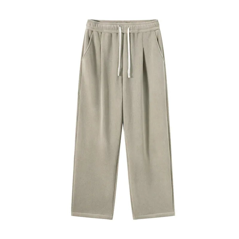 Man wearing apricot coloured loose-fit fleece-lined casual trousers with an elasticated waist.