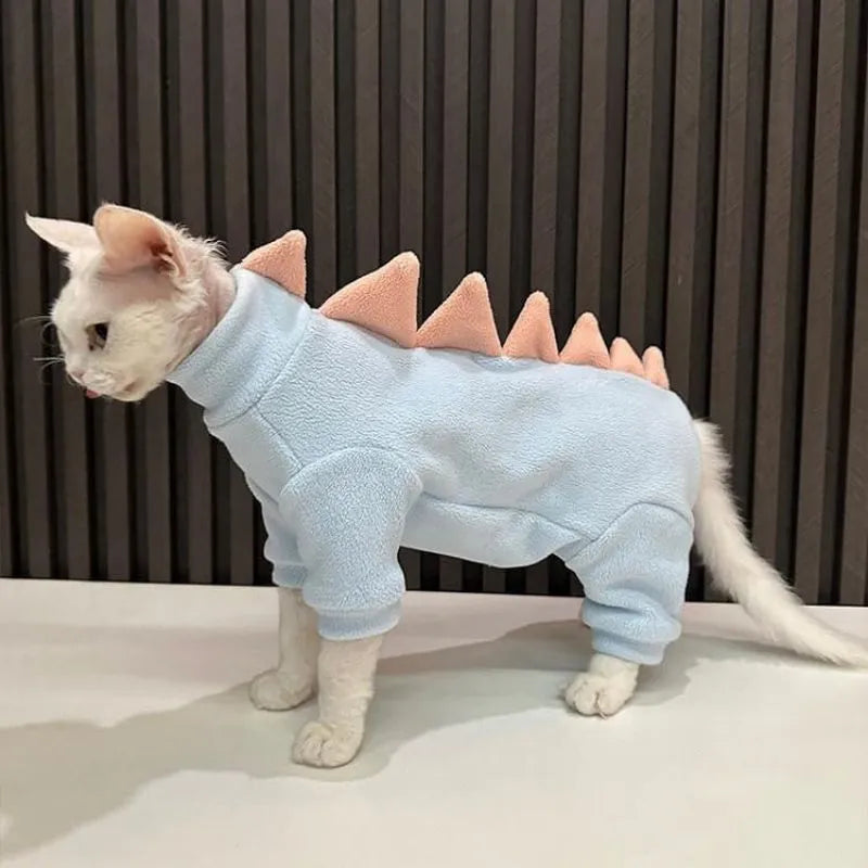 Sphynx cat wearing dinosaur costume with spikes and tail in soft fleece material