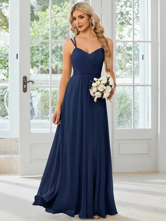 Women's sleeveless banquet dress with pleated A-line long skirt in light green, showing sling neckline.