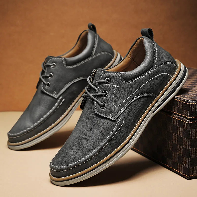 Men's black genuine leather casual lace-up shoes with round toe and rubber sole on a white background.