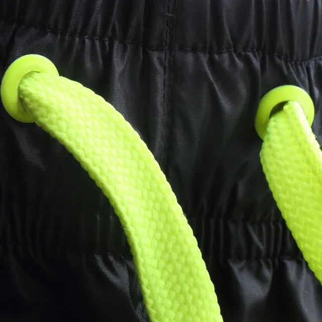Quick-drying breathable gym running pants in fluorescent green – 100% polyester thin fabric with micro-elasticity, side view on treadmill