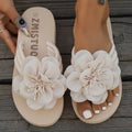 Women's solid colour PU flower flip-flops on a flat surface, showing the strap with decorative flower detail