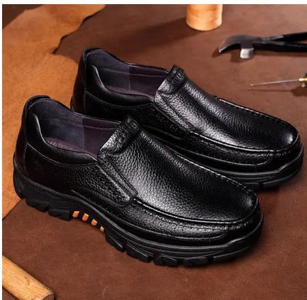 Men's black and brown business casual slip-on shoes made from cowhide leather with rubber soles.