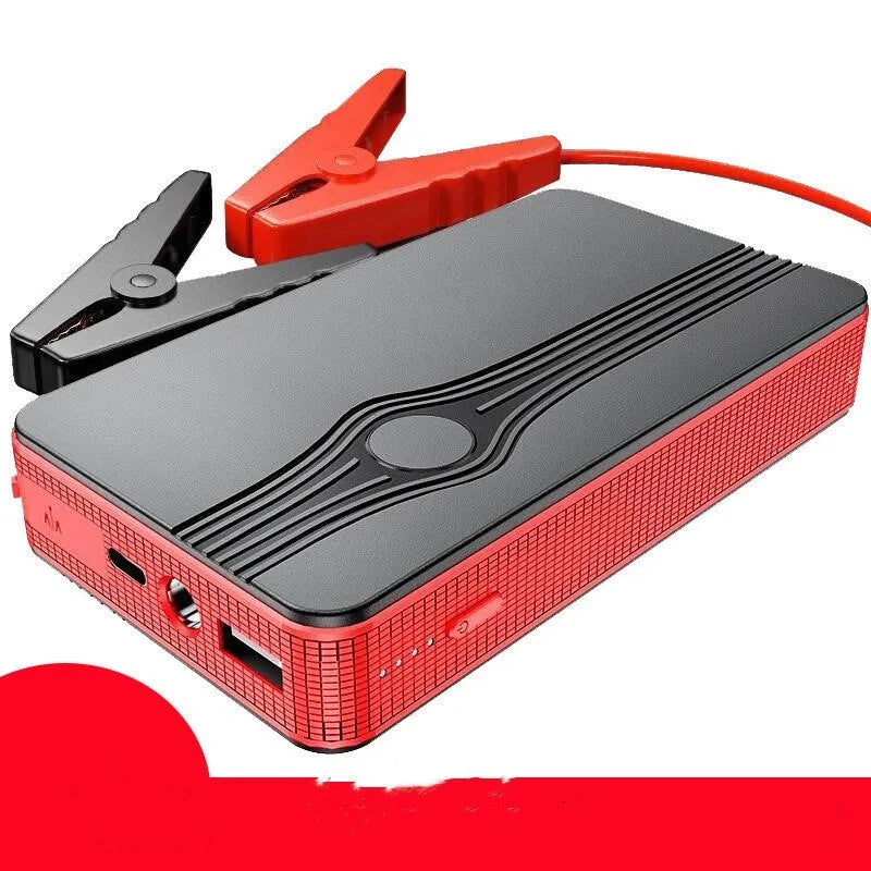 Red K4-E portable car jump starter and power bank with data cable, showing compact size for vehicle glovebox storage.