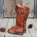 Black women's chunky heel high-leg boots with a round toe and short stout heel on a plain background.