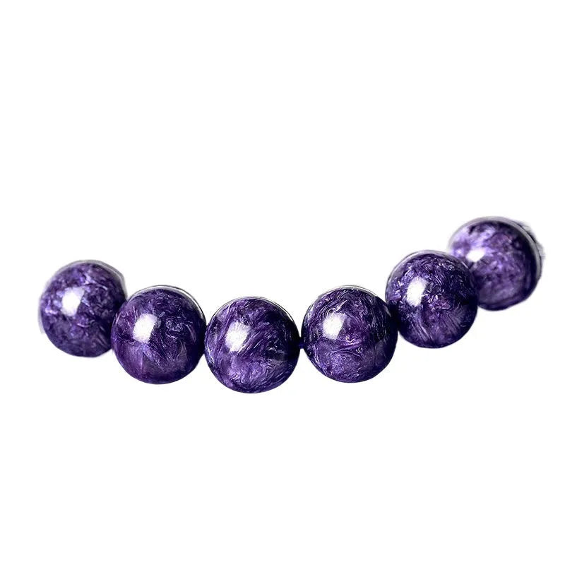 Natural transparent charoite crystal bracelet with platinum metal accents in hands bead design