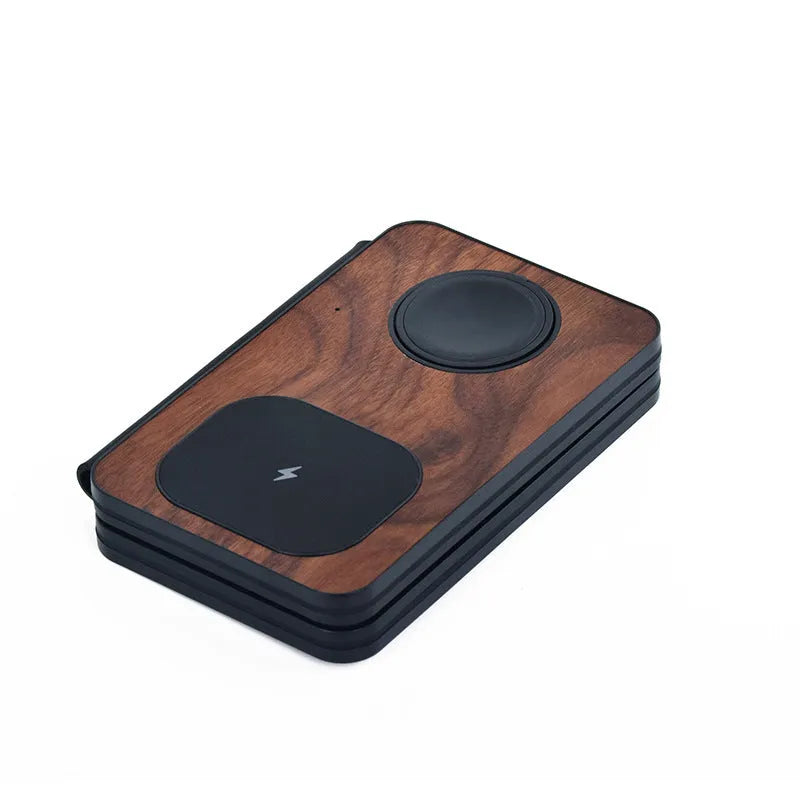 Three-in-one foldable magnetic wireless charger with walnut base and stand, charging a phone, earbuds and watch.