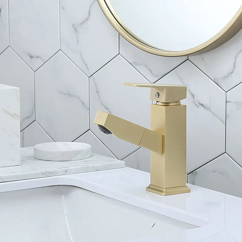 Square handle brushed gold pull faucet with brass construction on a sink.